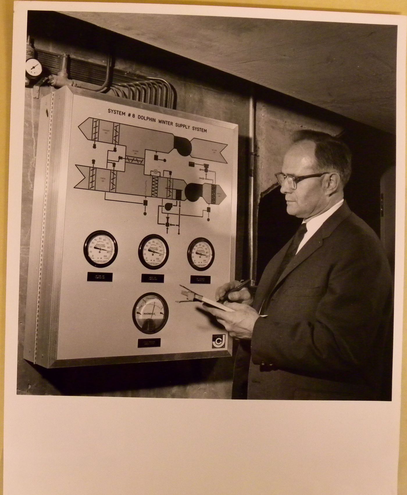 View of Lucien Rodrigue controlling the water supply system at the Alcan Dolphin Pool, Expo 67, Montréal, Québec