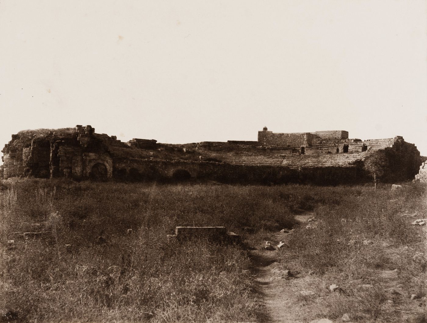 View of the ruins of a Roman amphitheater showing tiers of seats, Jebel ed Druz, Ottoman Empire (now in Syria)