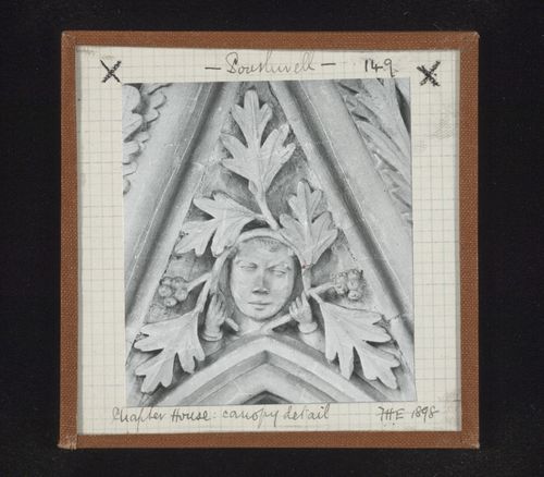 Detail view of canopy with foliate mask on tympanum in Chapter House, Southwell Minster, Southwell, Nottinghamshire, England