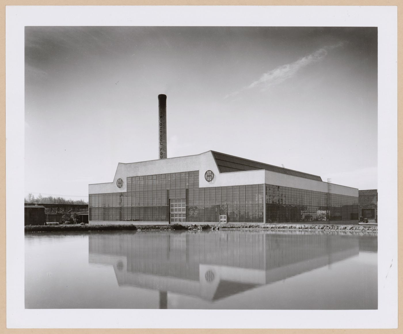 General view of the principal [?] façade of the Roll and Heavy Machine Shop from across a river [?], Ohio Steel Foundry, Lima, Ohio