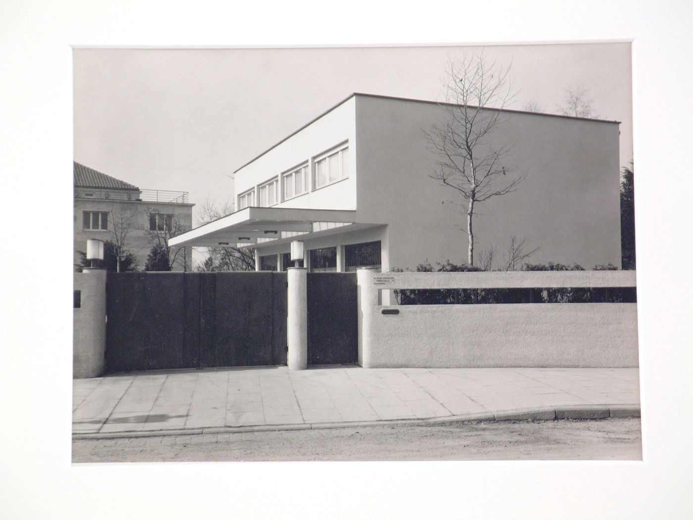 View from street Bloch home or office of Dr. Edgar Oppenheimer, Gerokstrasse [?] 40, surrounded by stucco-surfaced wall, Germany