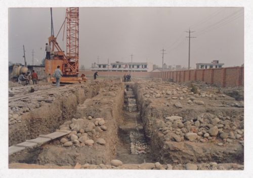 Workers on the site of housing under construction in China, possibly related to Sichuan housing project