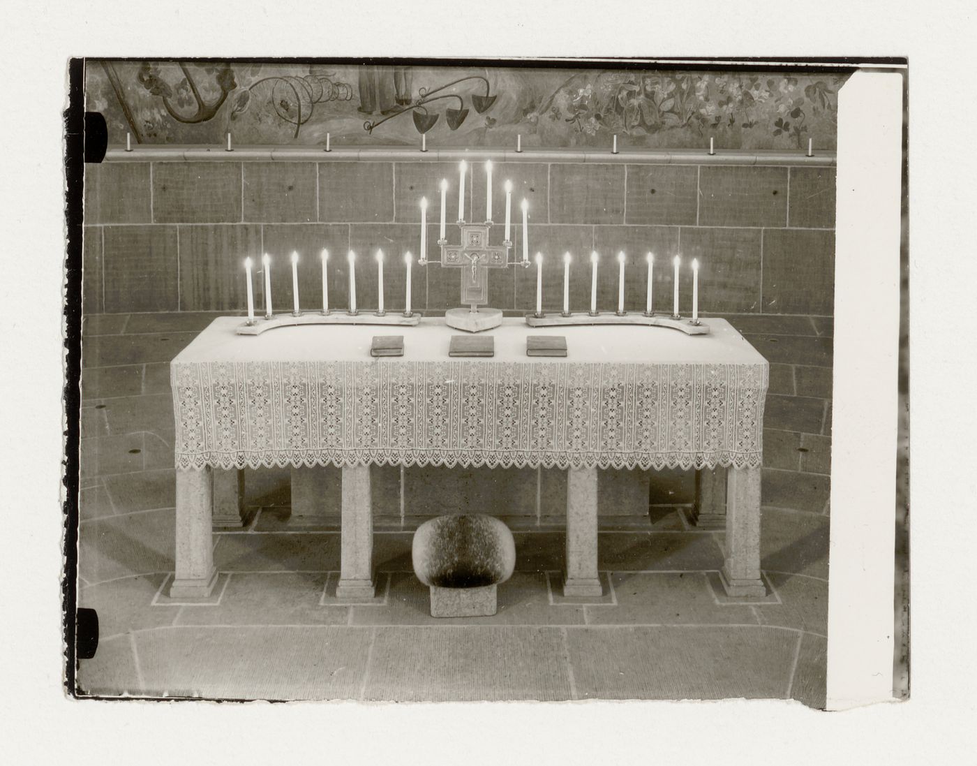 Interior view of the Chapel of the Holy Cross showing the altar dressed with an altar cloth, crucifix and candles, Woodland Crematorium and Cemetery, Stockholm