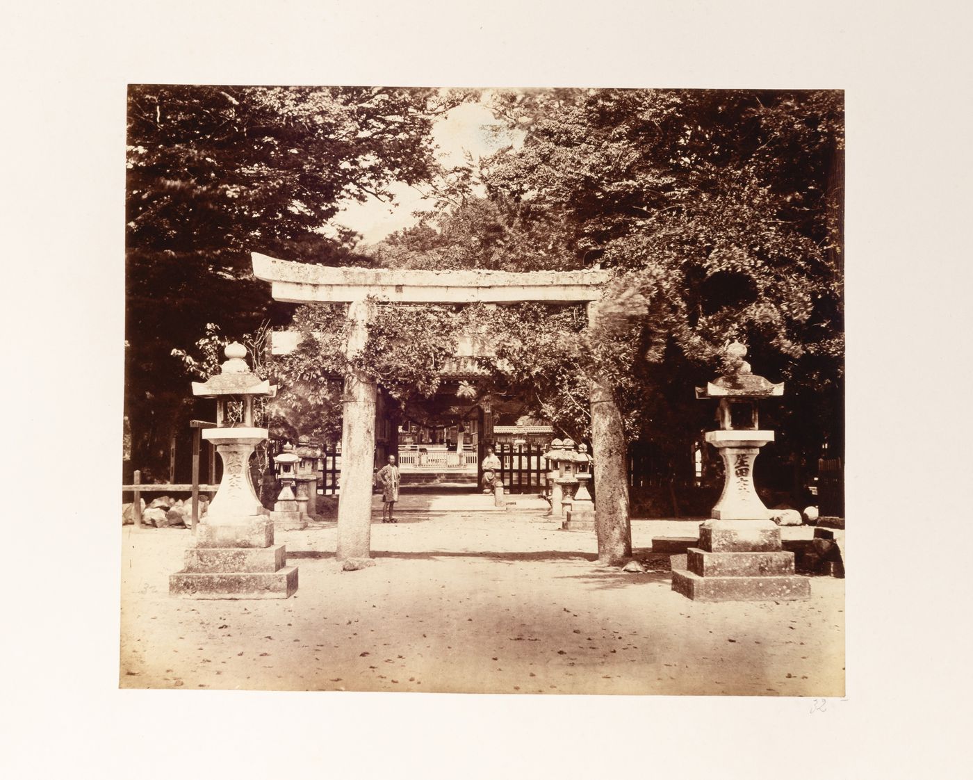 View of a torii, stone lanterns and wooden fences at the Ikuta Shrine complex, Kobe, Japan