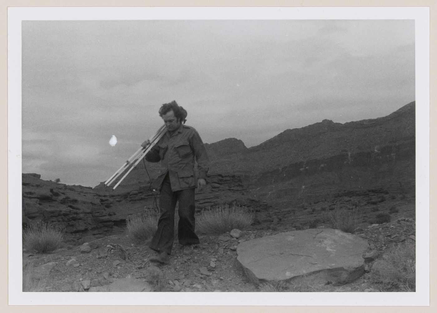 Photograph of Gianni Pettena in front of rock formations for About None Conscious Architecture