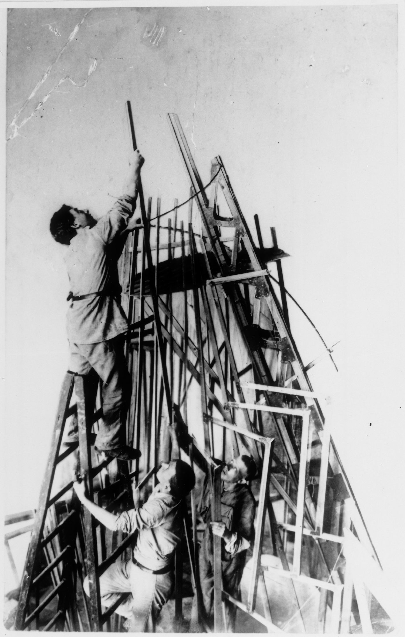 Vladimir Tatlin and his assistants I.A. Meerzon and T.M. Shapiro constructing the first model for the monument to the Third International, Petrograd, Soviet Union (now Saint Petersburg, Russia)