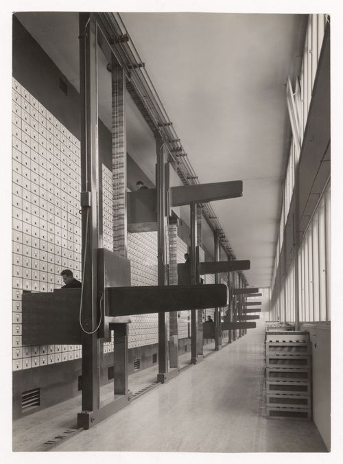 Interior view of the Central Social Insurance Institution showing men working in mobile work stations used to access the card catalog drawers, Prague, Czechoslovakia (now Czech Republic)
