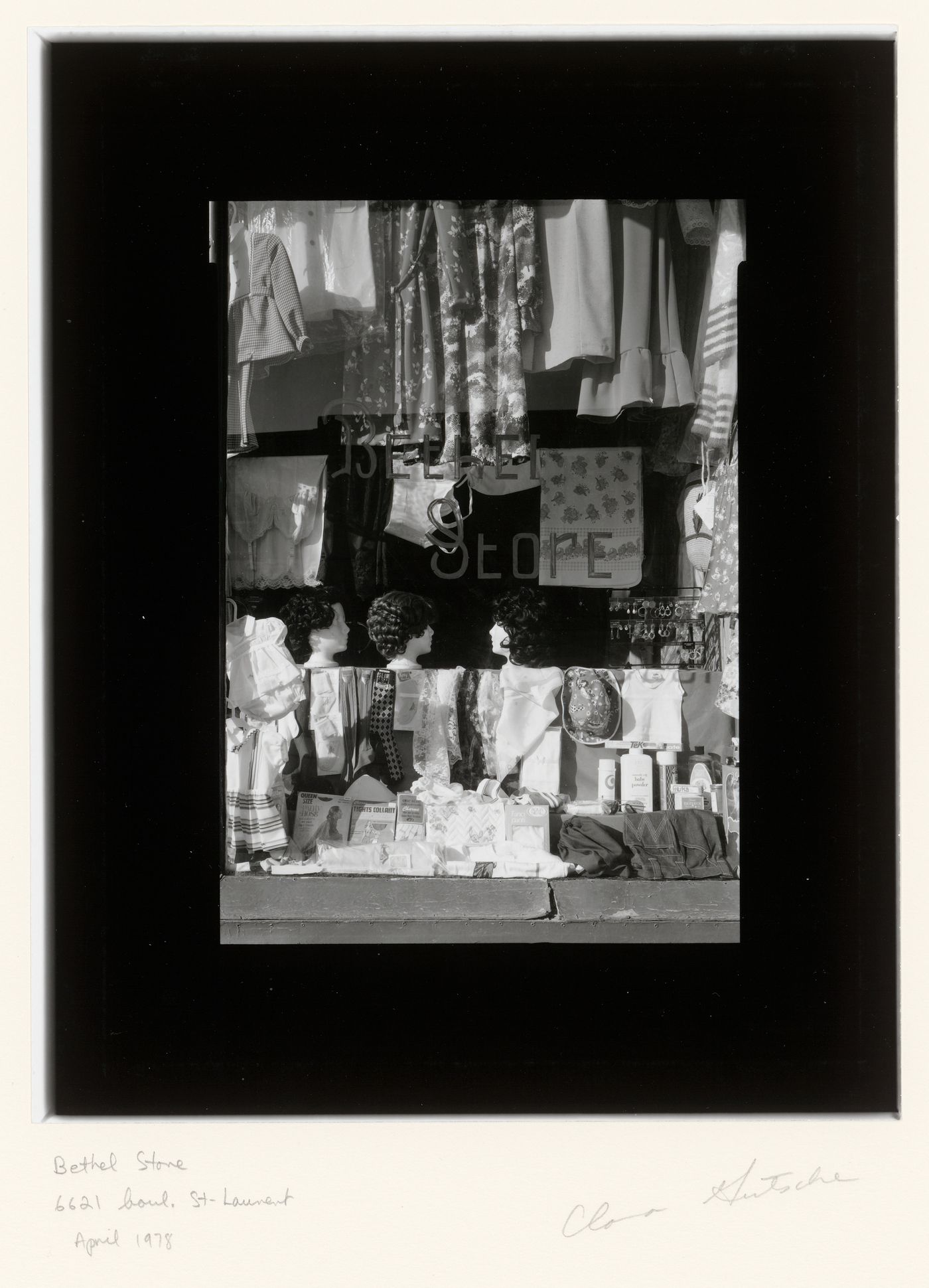 View of a display window of the Bethel Store showing clothes, wigs, jewelry and cosmetics, 6621 boulevard Saint-Laurent, Montréal, Québec