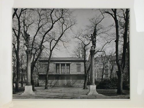 View of the Schinkelpavillon (also known as the Somerhaus and the Neue Pavillon) with two statues on top of granite columns in the foreground, Schloss Charlottenburg Park, Charlottenburg, Berlin, Germany