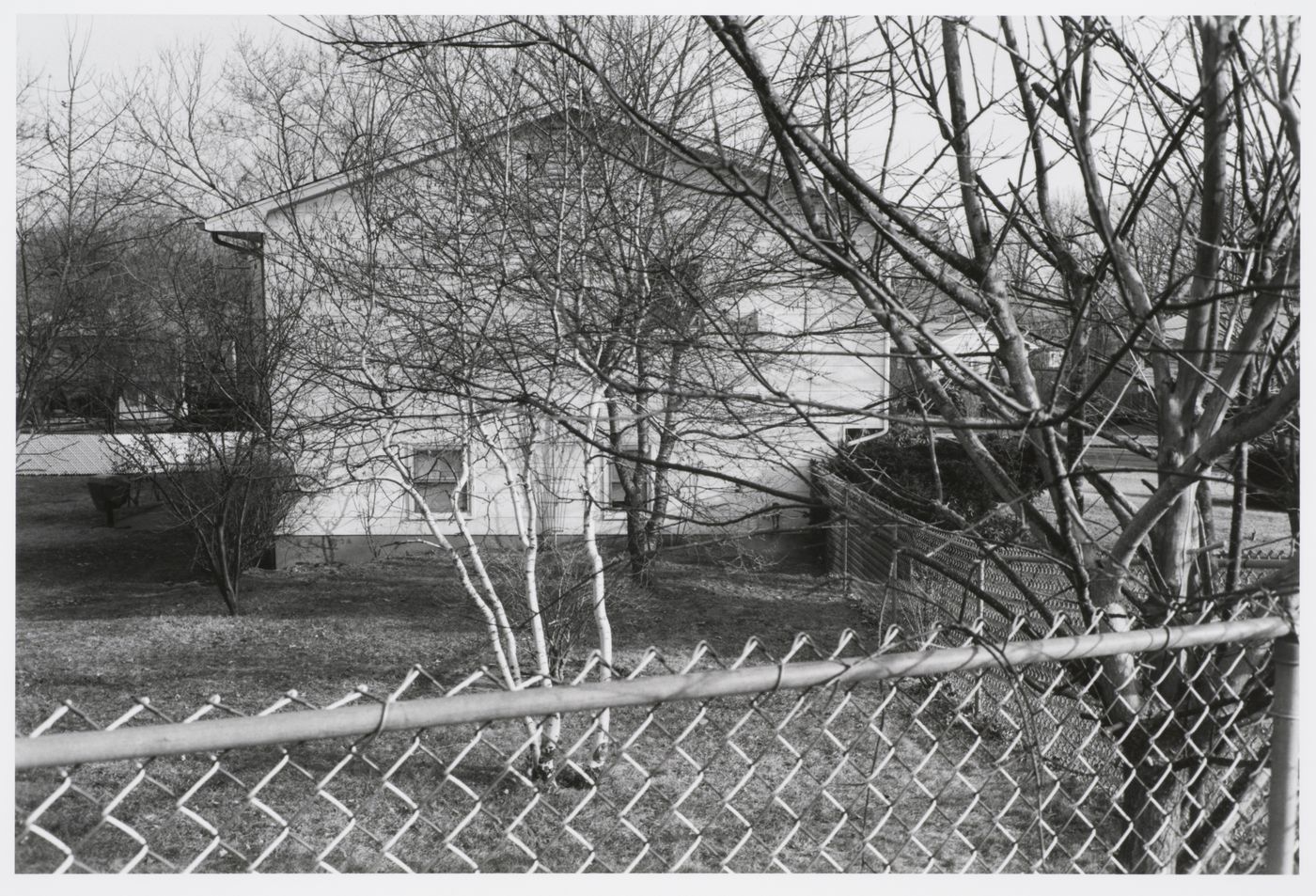 View of suburban house and wire fence, Ramapo, New York, United States