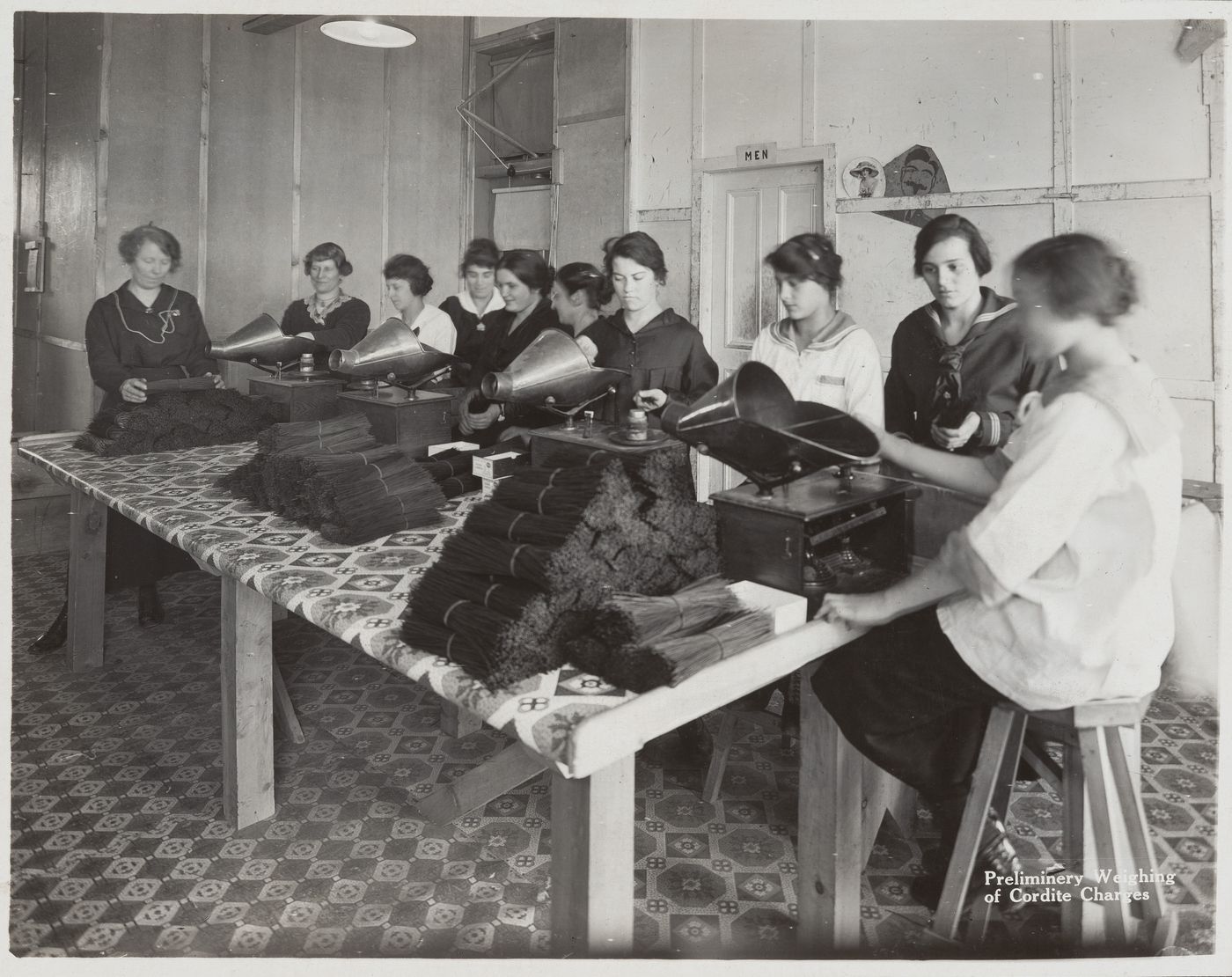 Interior view of workers weighing cordite charges at the Energite Explosives Plant No. 3, the Shell Loading Plant, Renfrew, Ontario, Canada