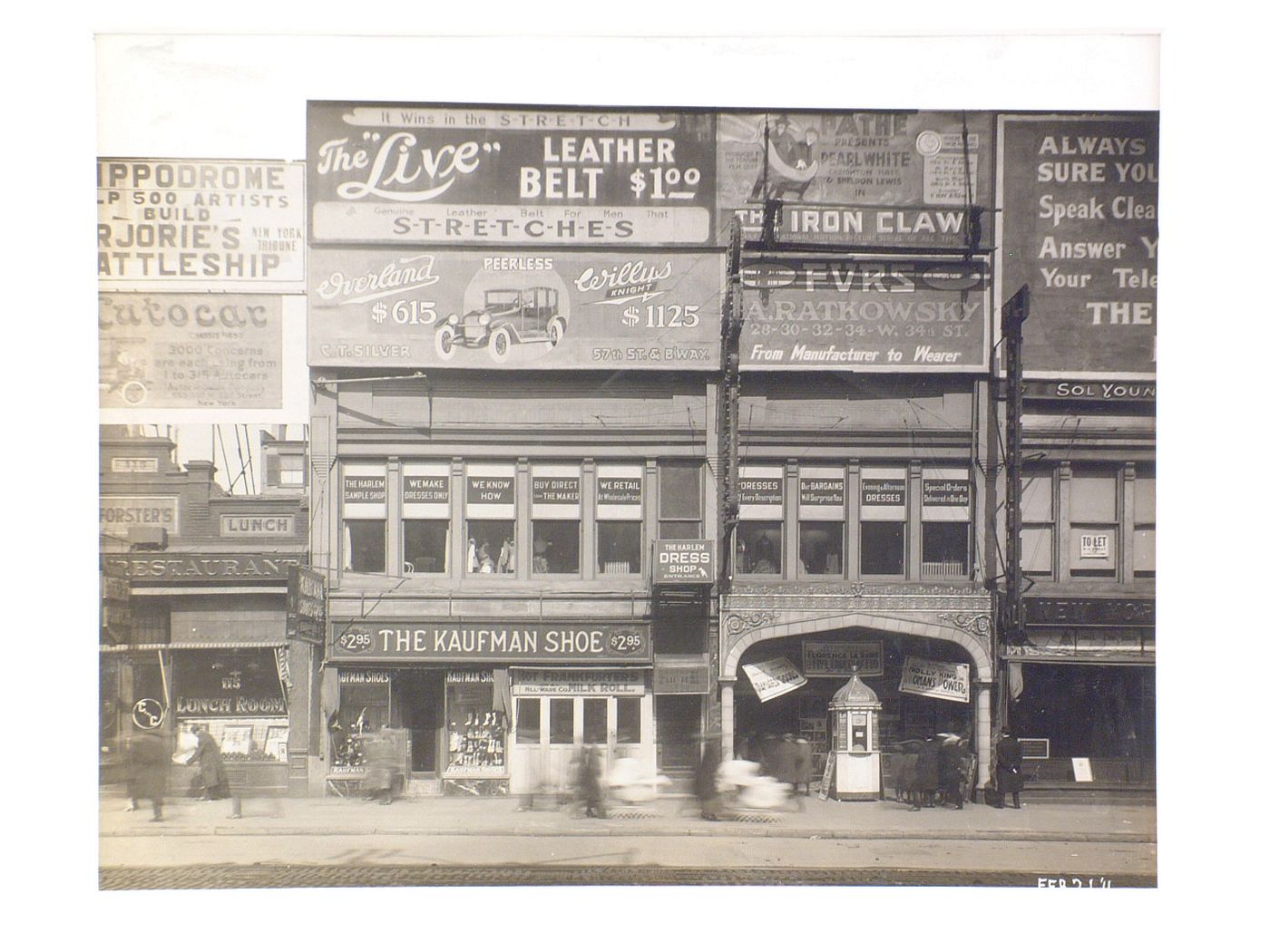 Billboards on 125th Street between Lenox Avenue and Seventh Avenue, Harlem, New York City: The Kaufman Shoe, The Harlem Dress shop, Pathé Theatre (‘The Iron Claw’), Peerless Motors, Hippodrome Theatre.