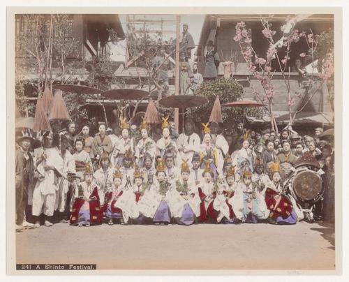 Group portrait of people in front of a Shinto shrine, Japan