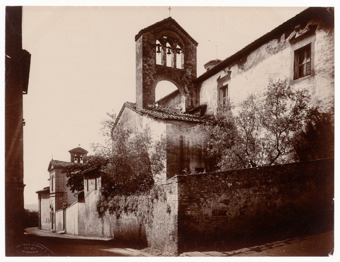 Partial view of a church showing a bell tower, Siena, Italy