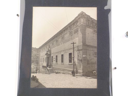 View of the eastern façade of the Alhóndiga de Granaditas (now the Museo de la Alhóndiga de Granaditas) showing a street and people in the foreground, Guanajuato, Mexico