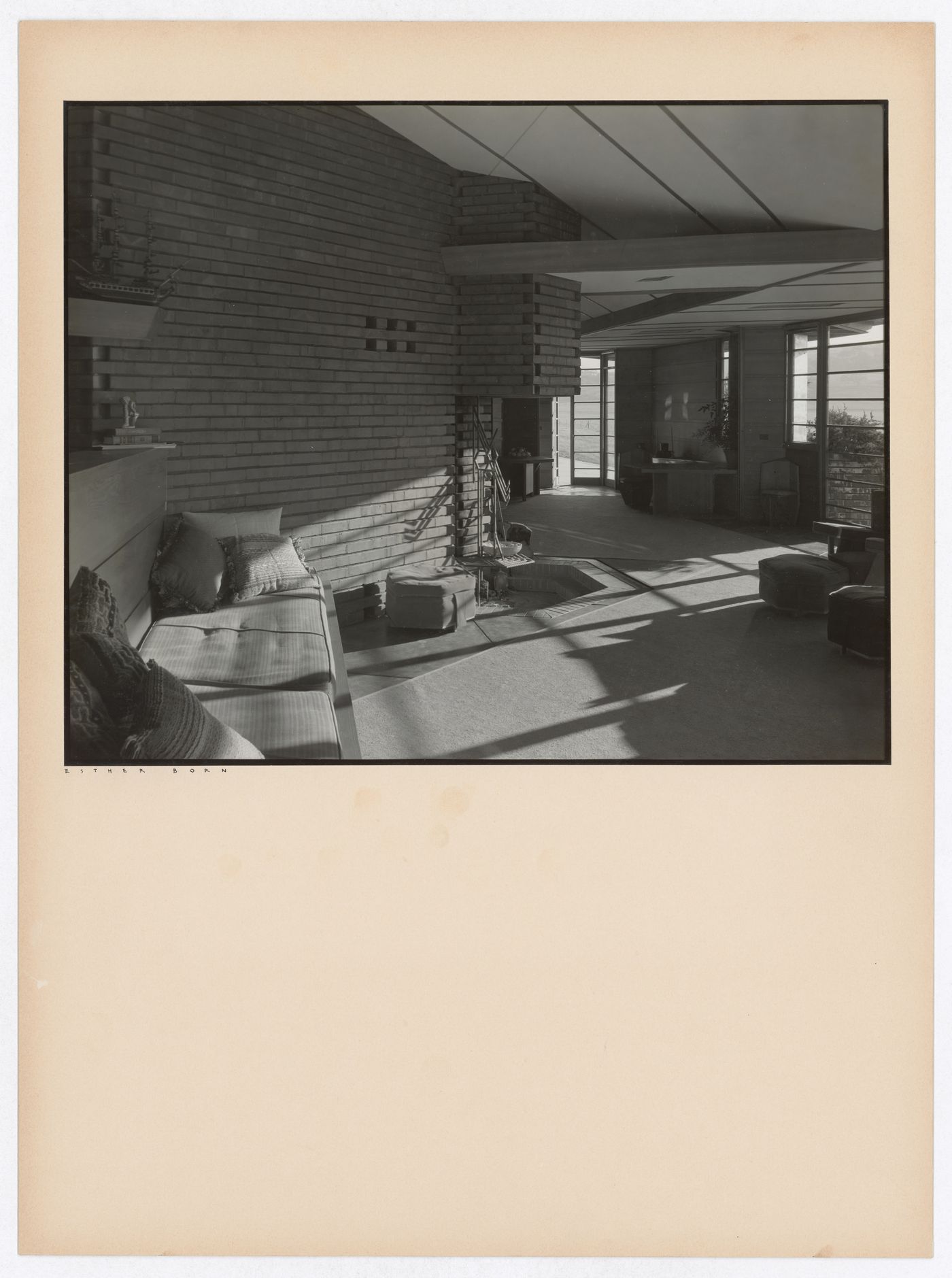 Interior view of the Hanna House showing windows, a fireplace, and seating furniture, Palo Alto, California, United States