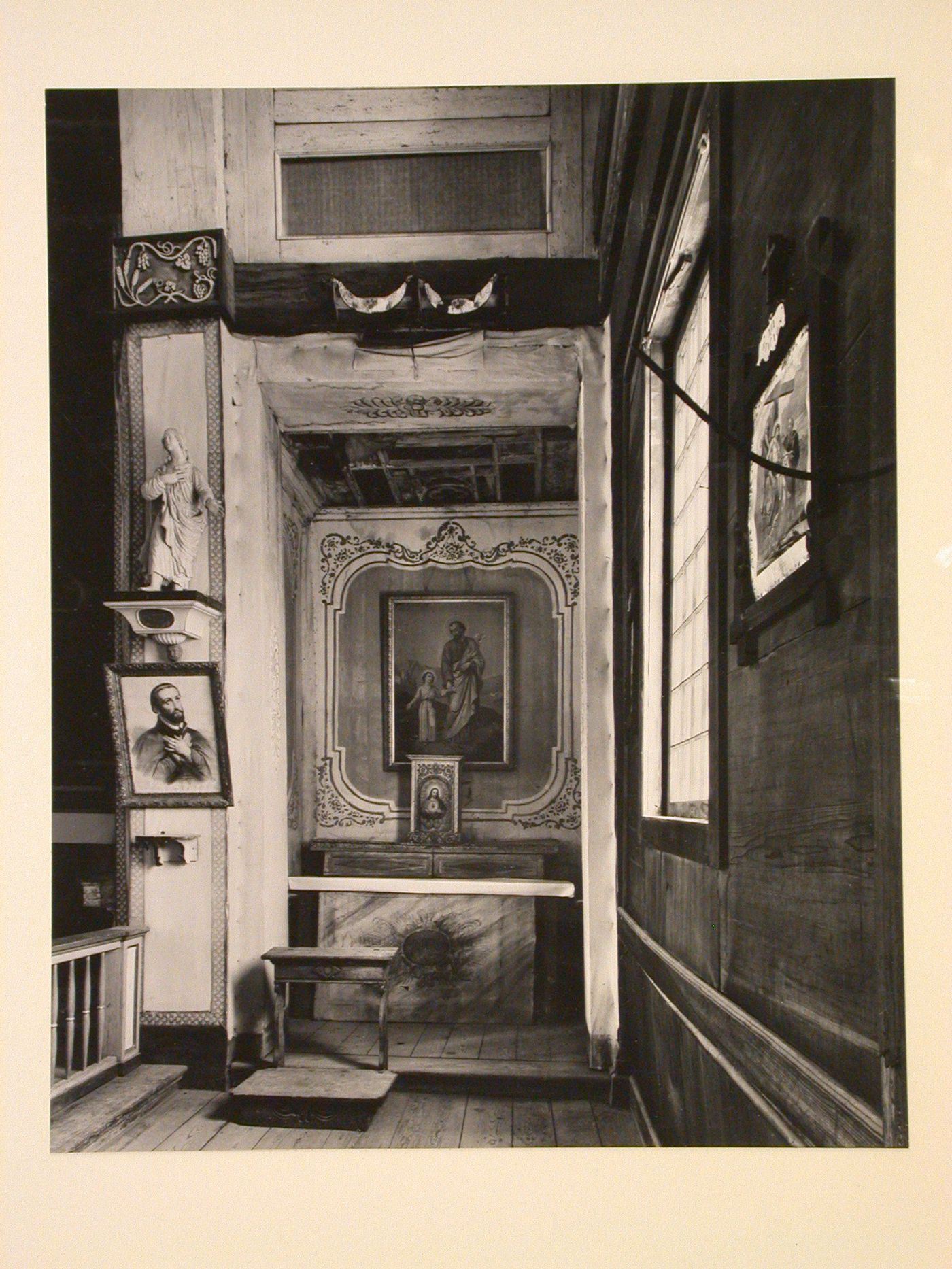 Interior view of the Church of the Sacred Heart showing the right altar, a statue of the St. John carved by Anthony Ravalli and a lithograph of St. Francis Xavier, Cataldo, Idaho