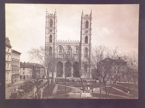 View of Notre Dame with horse and carriages and trees in foreground, Montreal, Quebec, Canada