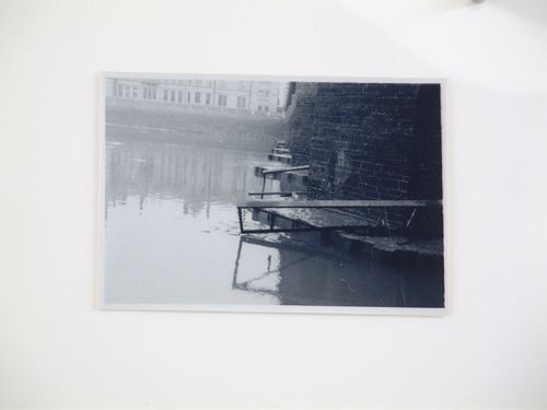 View of steel beams at base of brick bridge over water