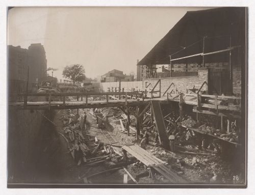 Construction of the Paris Metro, exterior construction view of wooden bridge over work area, Paris, France