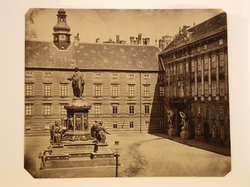Castle courtyard with statues of Roman figures inscribed "Amoren.meum.populis.meis", Vienna, Austria