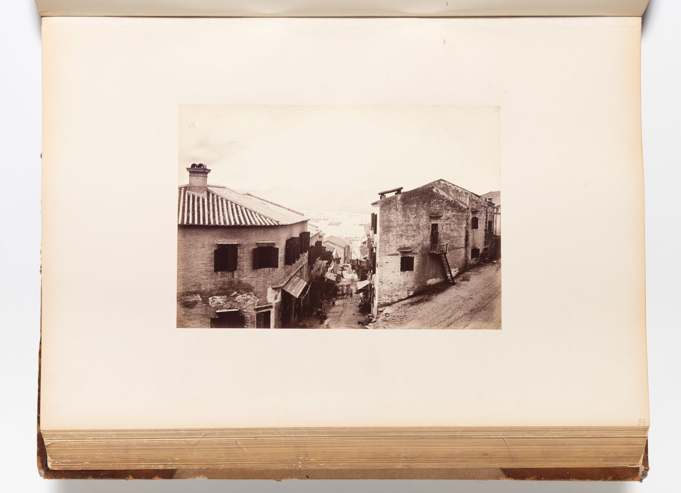 View of streets and buildings showing the harbour in the distance, Hong Kong (now Hong Kong, China)