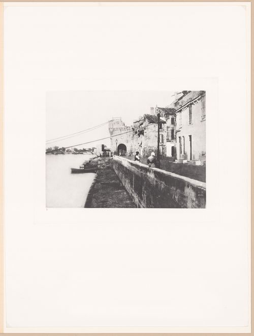 View of river, river wall, houses and fortifications, Arles, France