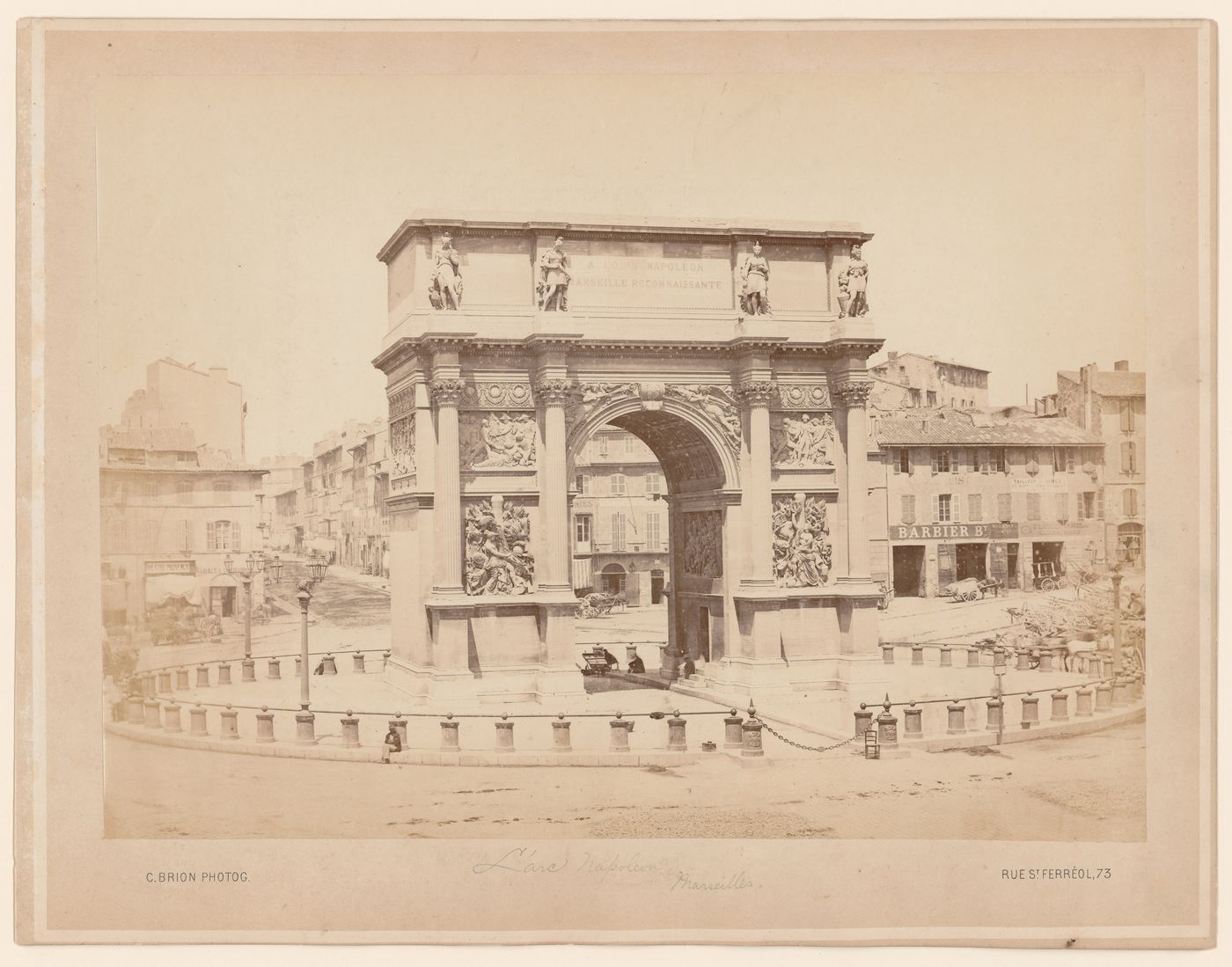 View of l'Arc Napoléon and many buildings on street in the background, Marseille, France