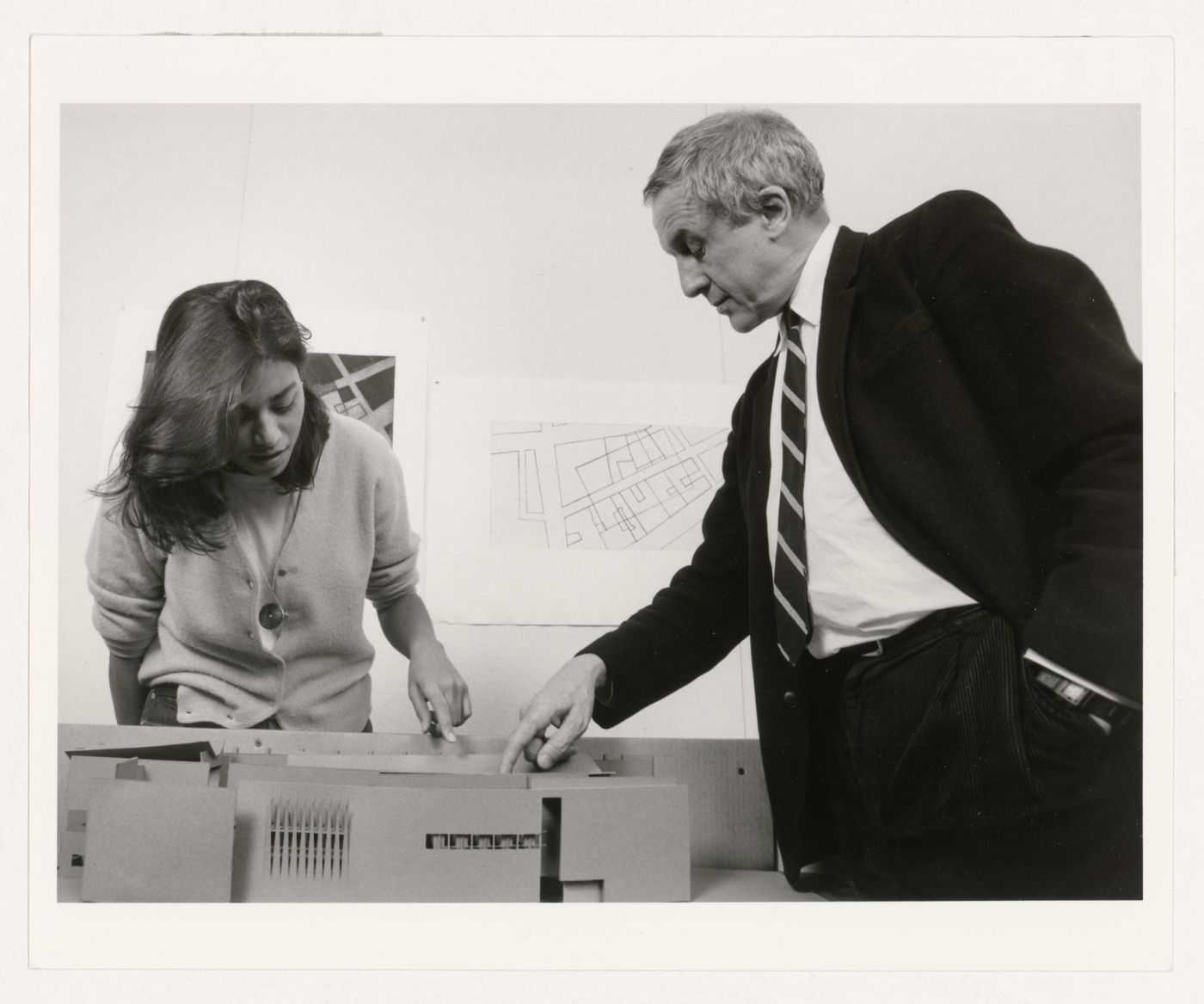 Kenneth Frampton and unidentified person (student?) looking at a model