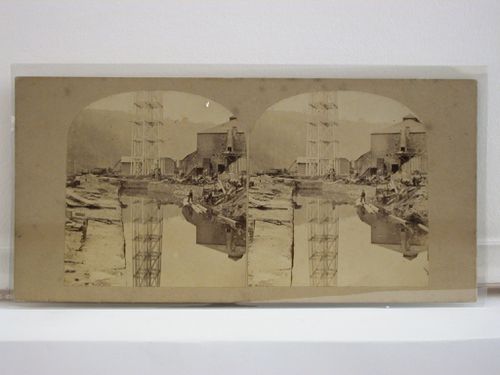 Stereograph of the Crumlin Viaduct under construction showing one of the structural piers and a building site [?], Monmouthshire (now in Gwent County), Wales