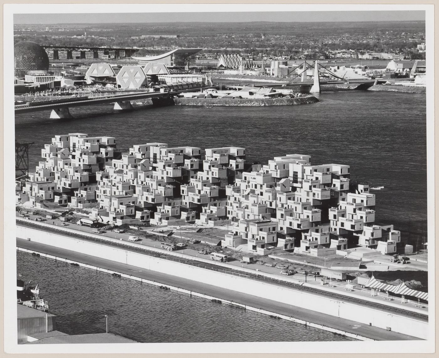 St. Lawrence river with Habitat - the city's most explosive residential complex. Ste Helene Island with Expo '67 site in background, Montreal, Quebec