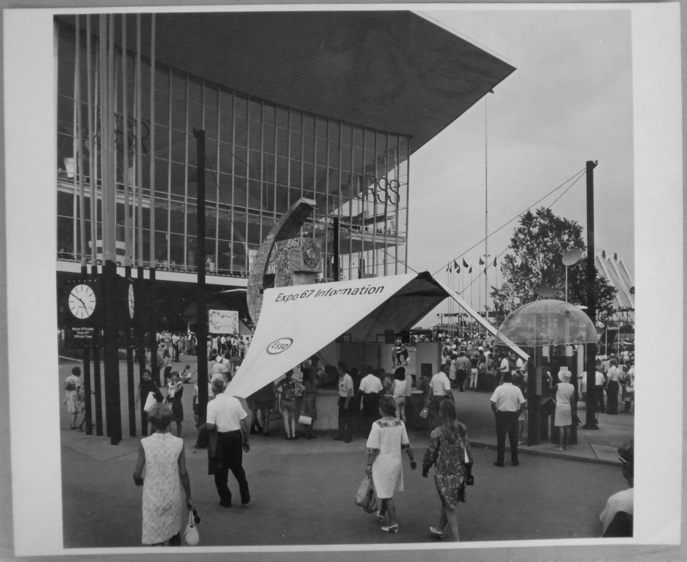 View of an information kiosk and a telephone booth in front of the Pavilion of the Soviet Union, Expo 67, Montréal, Québec