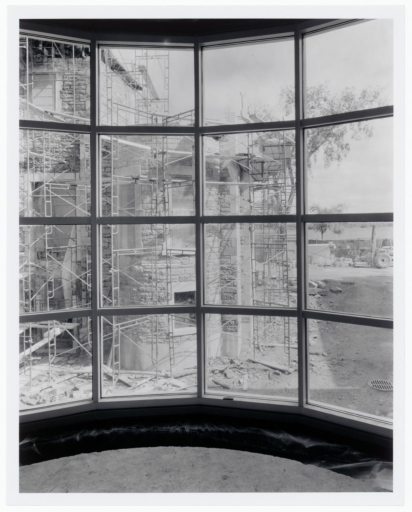 View through the bay window of the Entrance Court Rotunda showing Shaughnessy House surrounded by scaffolds, Canadian Centre for Architecture under construction, Montréal, Québec