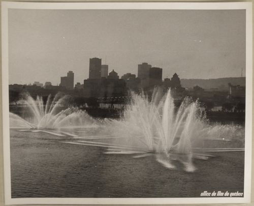 Partial view of the Dancing Waters show at the Dolphin Lake at La Ronde with Montréal as background, Expo 67, Montréal, Québec