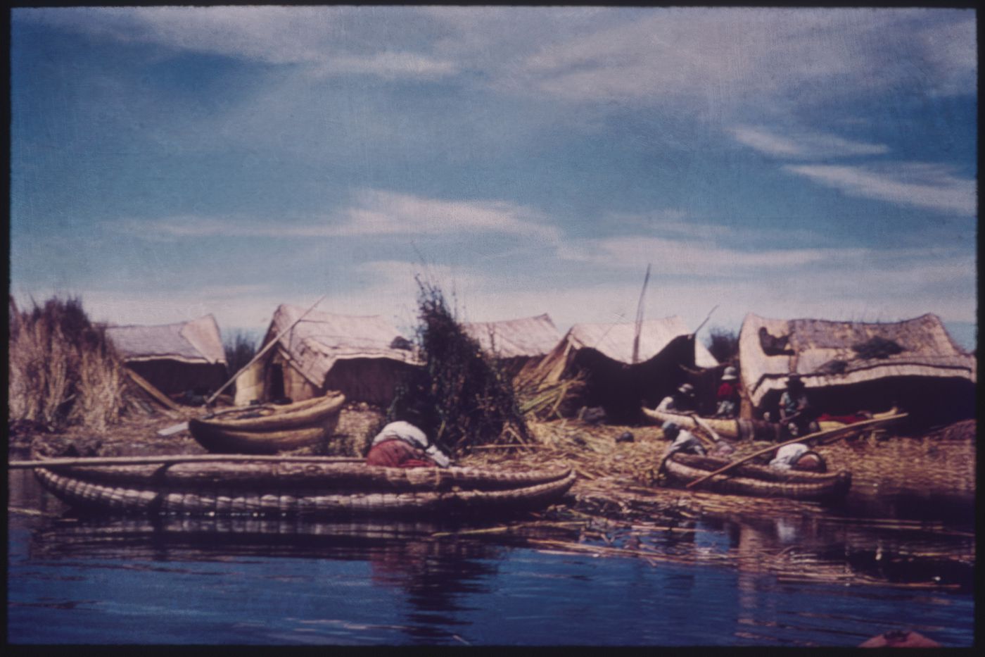 Portrait of some Qhas Qut suñi (Uru people) near the water's edge on a floating island on Titicaca Lake, Peru and Bolivia