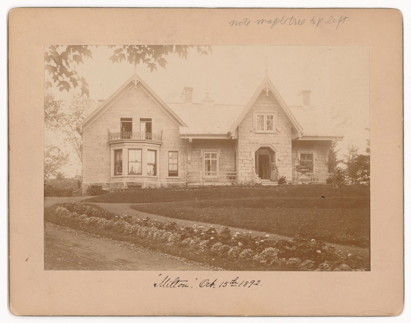 View of the principal façade of a house showing two women on the stairs, rue Milton, Montréal, Québec