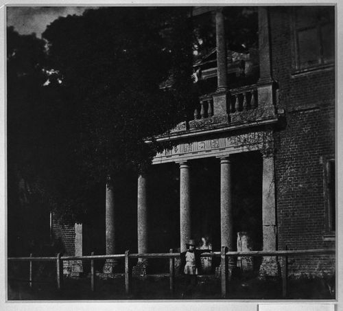 View of unidentified building with columned porches on two floors, and a figure in the foreground, England ?