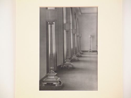Interior, detail of hallway with many large floor-lamps near windows