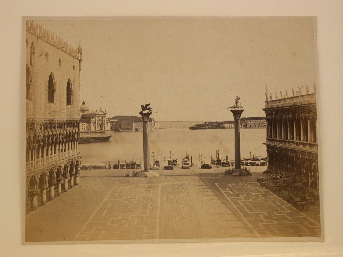 View from the Piazza San Marco looking towards the Grand Canal showing the Palazzo ducale, Biblioteca nazionale marciana, two columns with statues of the winged lion of Venice and St. Theodoro, and the Church of San Giorgio maggiore, Venice, Italy