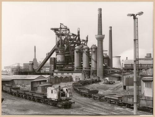 View of Metallhüttenwerk industrial plant showing blast furnace heads A, B, and C, Lübeck-Herrenwyk, Germany
