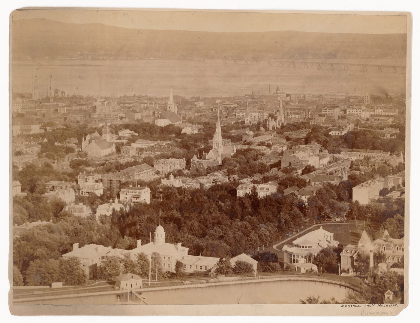 View of Montréal from Mount Royal showing the McTavish Reservoir in the foreground, Basilique Notre-Dame on the far left and Victoria Bridge on the far right, Québec