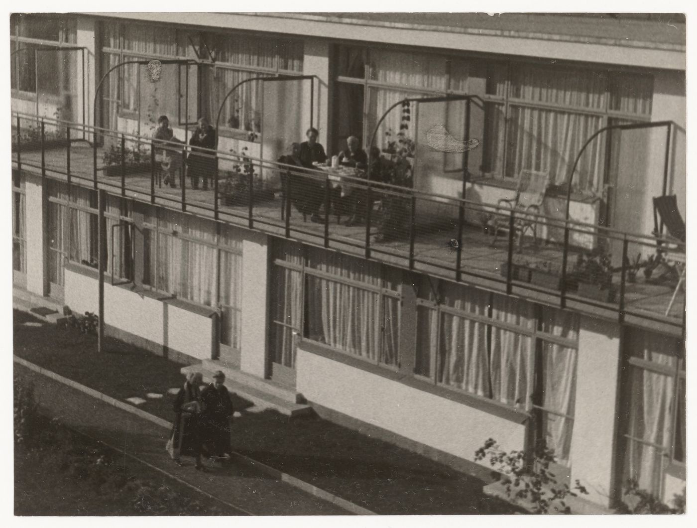 Exterior view of Budge Foundation Old People's Home showing residents sitting on the second-floor balconies, Frankfurt am Main, Germany