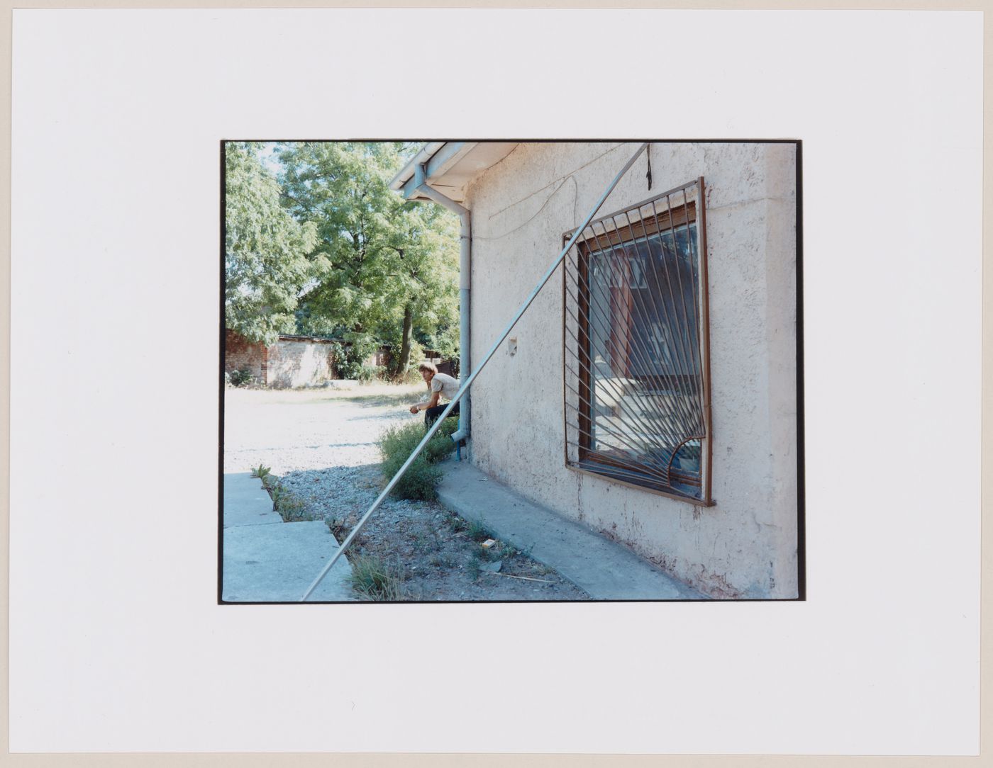Portrait of a man and a house showing a window with a grille, Ladushkin, Kaliningradskaia oblast', Russia (from the series "In between cities")