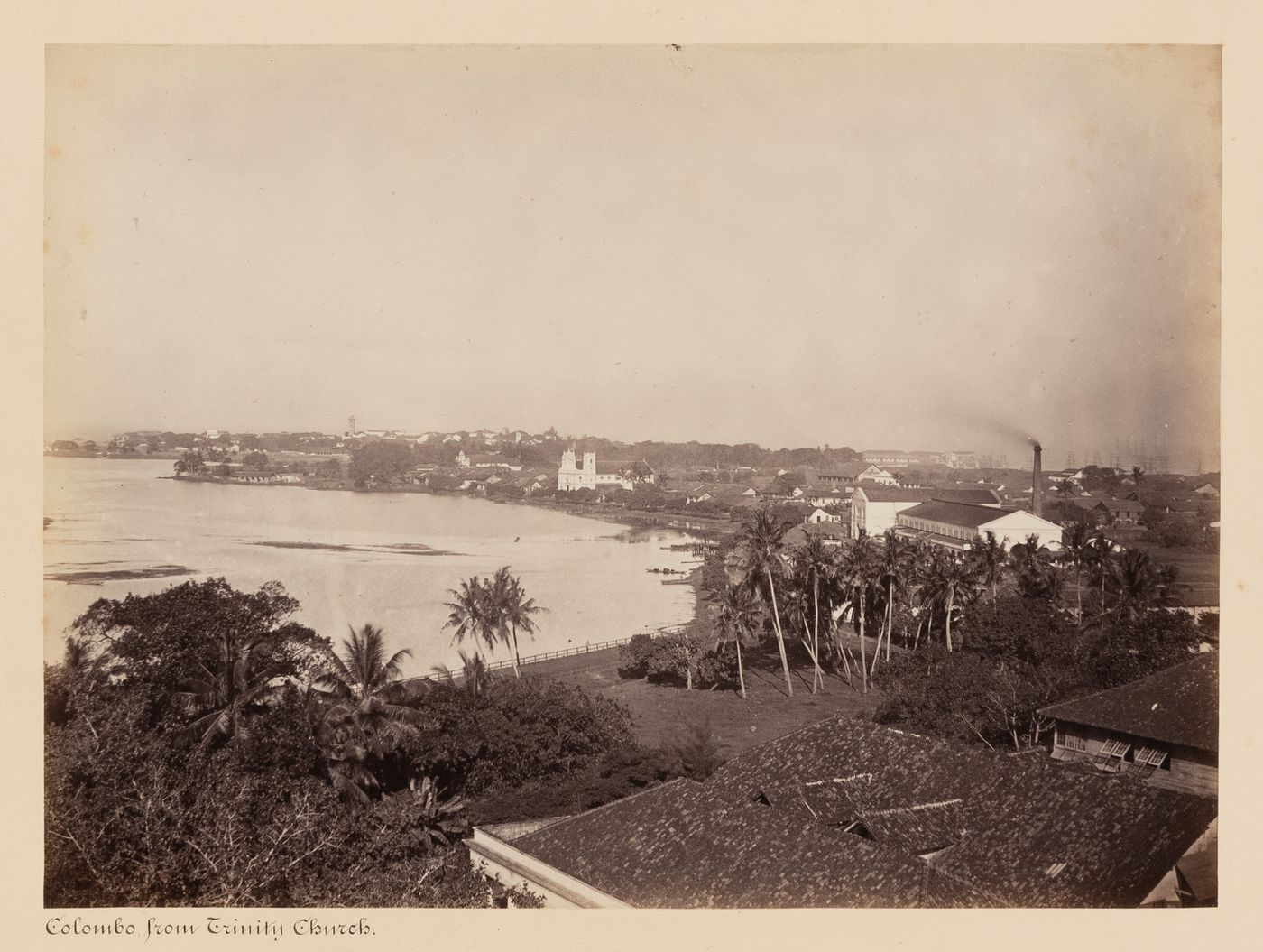 Panoramic view of Colombo showing Beira Lake and St. Philip's Church with the clock tower and lighthouse in the left background and the harbour in the right background, Colombo, Ceylon (now Sri Lanka)