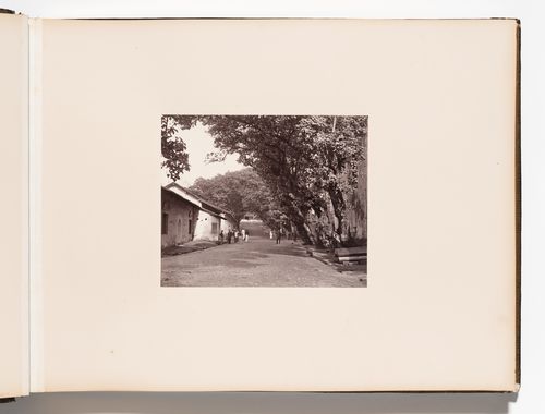View of a street showing unidentified buildings with a church tower in the left background, Point de Galle (now Galle), Ceylon (now Sri Lanka)
