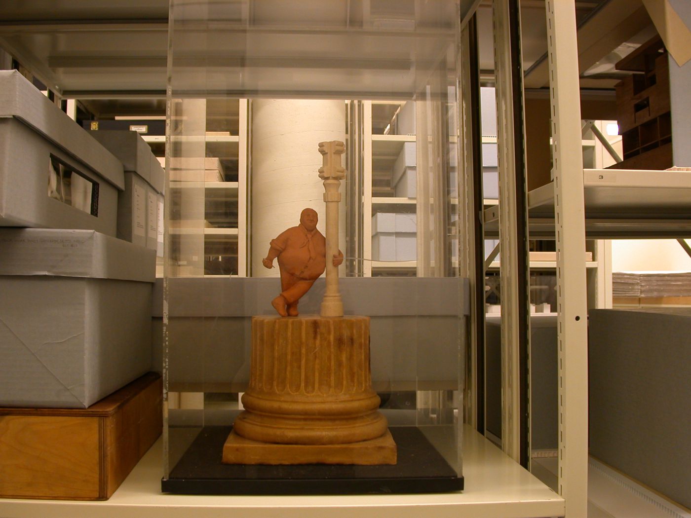 Sculpture of James Stirling standing on fragment of fluted column