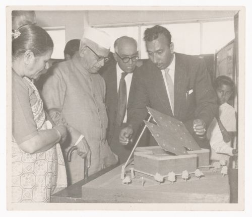 Photograph of M. N. Sharma showing the Tagore Theatre model to Bhim Sen Sachar and other unidentified people