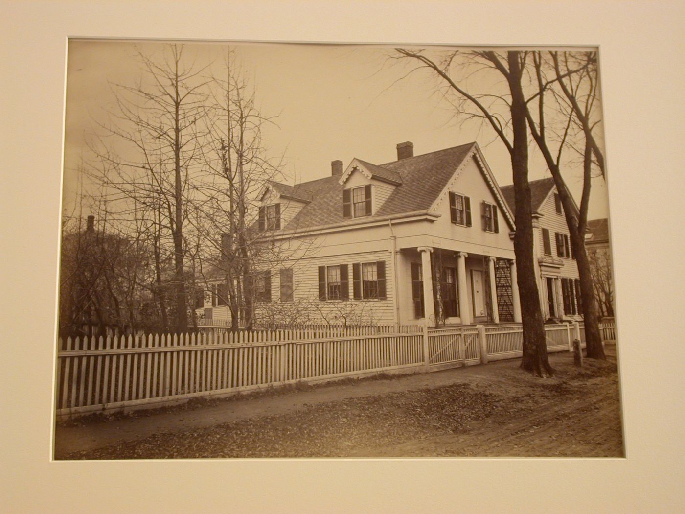 View of wooden clapboard house on street, white picket fences surrounding houses, Boston, Massachusetts