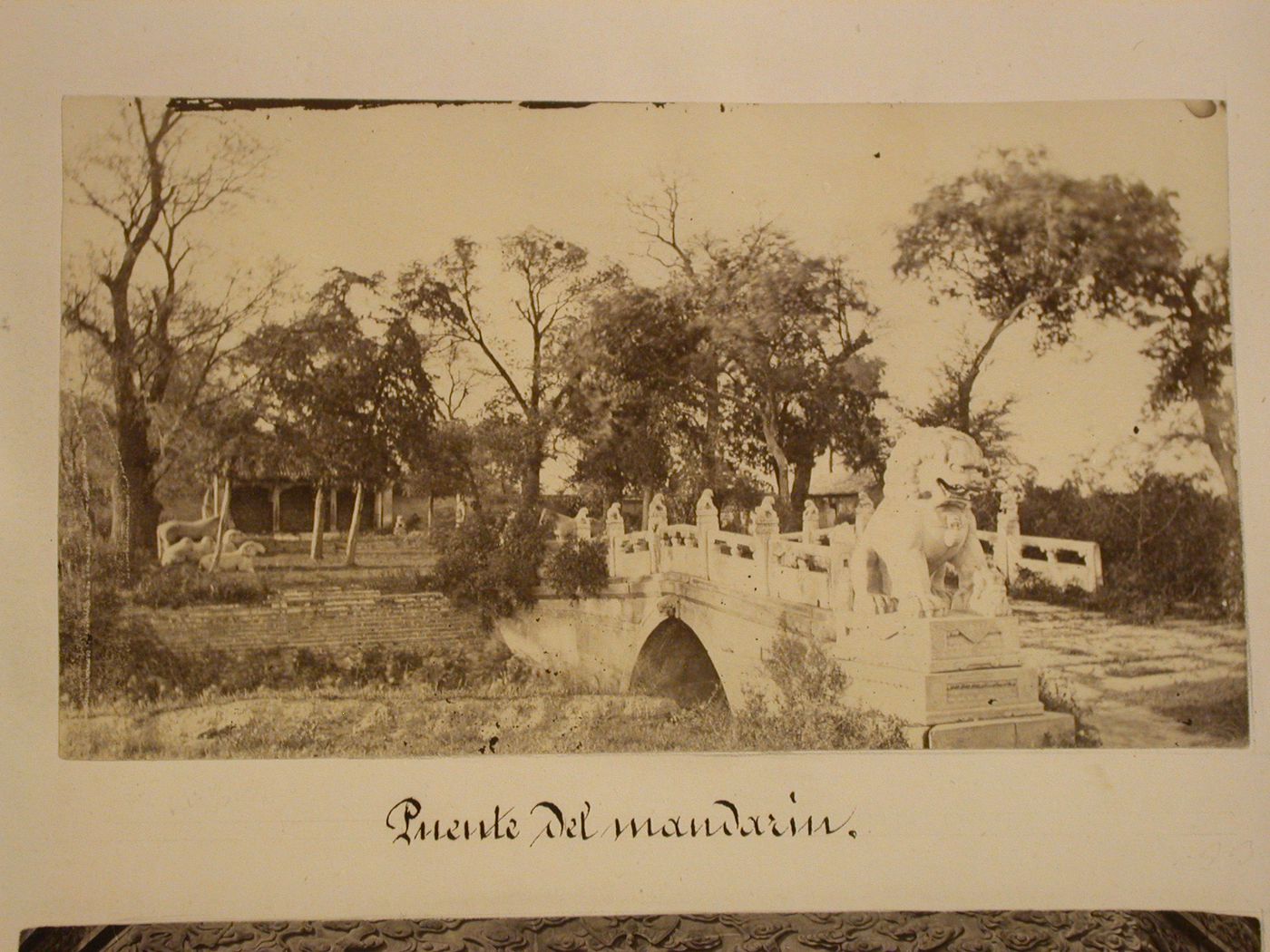 View of an arch bridge with a statue of a lion in the foreground, Peking (now Beijing), China