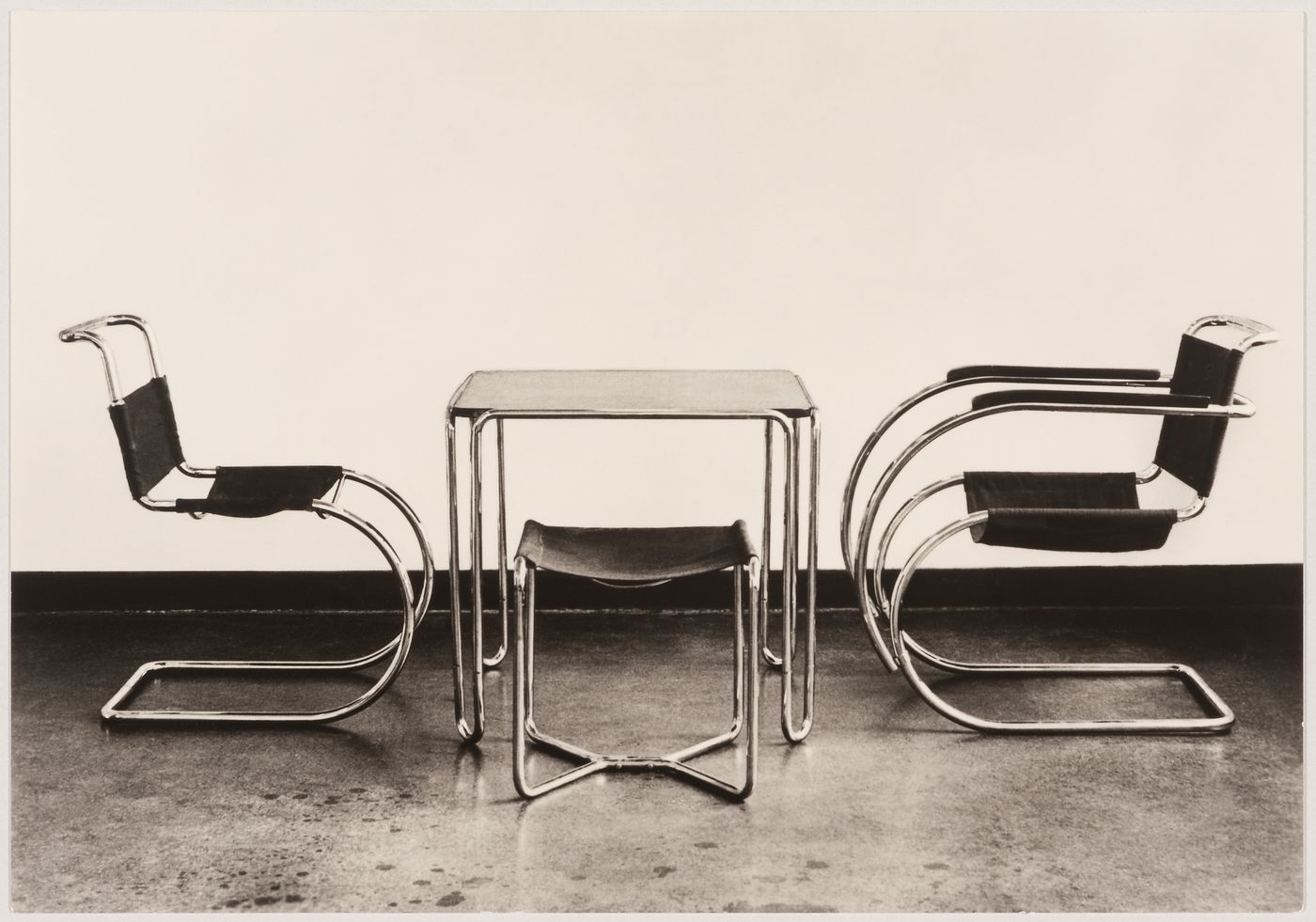 Interior view of the Bauhaus building showing two chairs designed by Mies van der Rohe and a table and stool designed by Marcel Breuer, Dessau, Germany